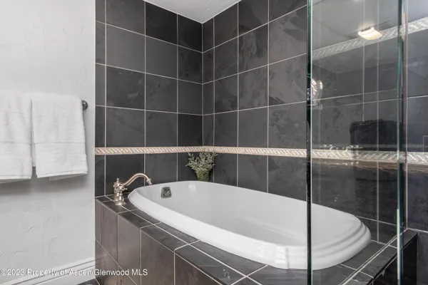 a spacious bedroom with two beds and a couch