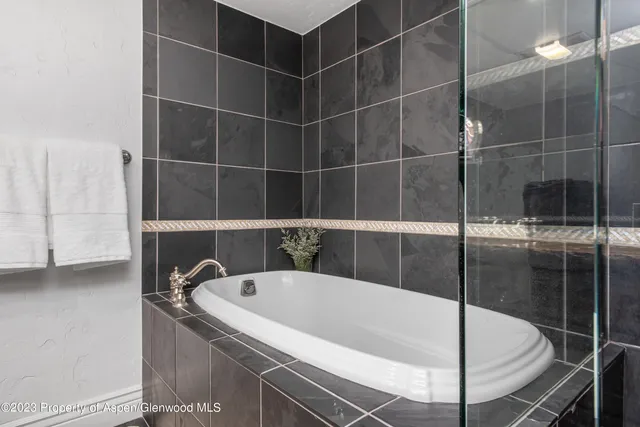 a spacious bedroom with two beds and a couch