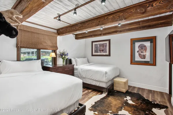 a bathroom with a granite countertop sink a mirror a bathtub and shower