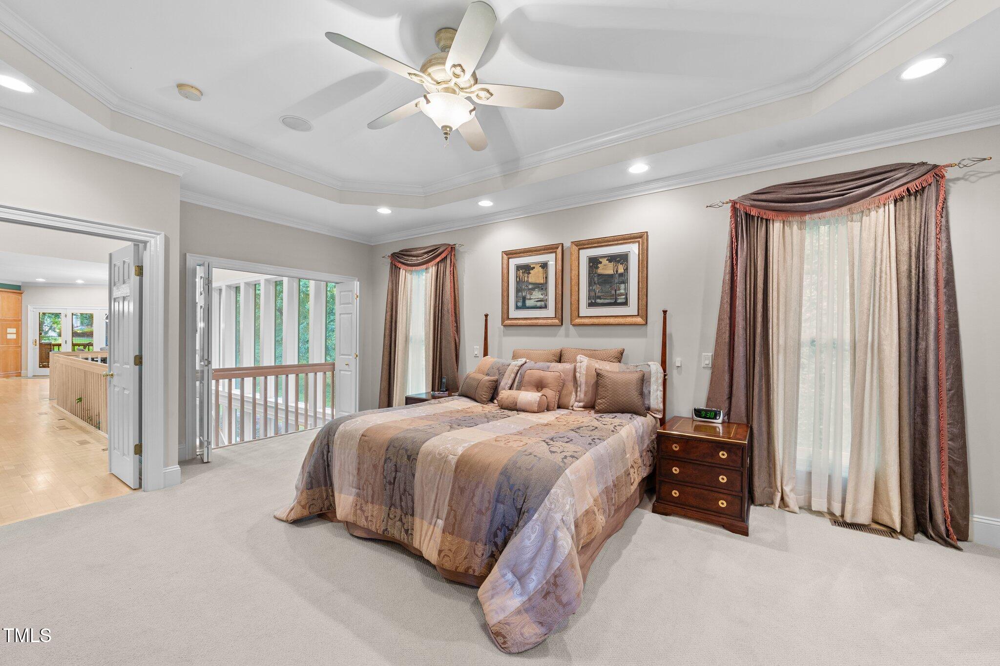 12504 Bayleaf Church Road Raleigh, NC 27614 - Photo 22 of 73 a bedroom with a large bed and a chandelier