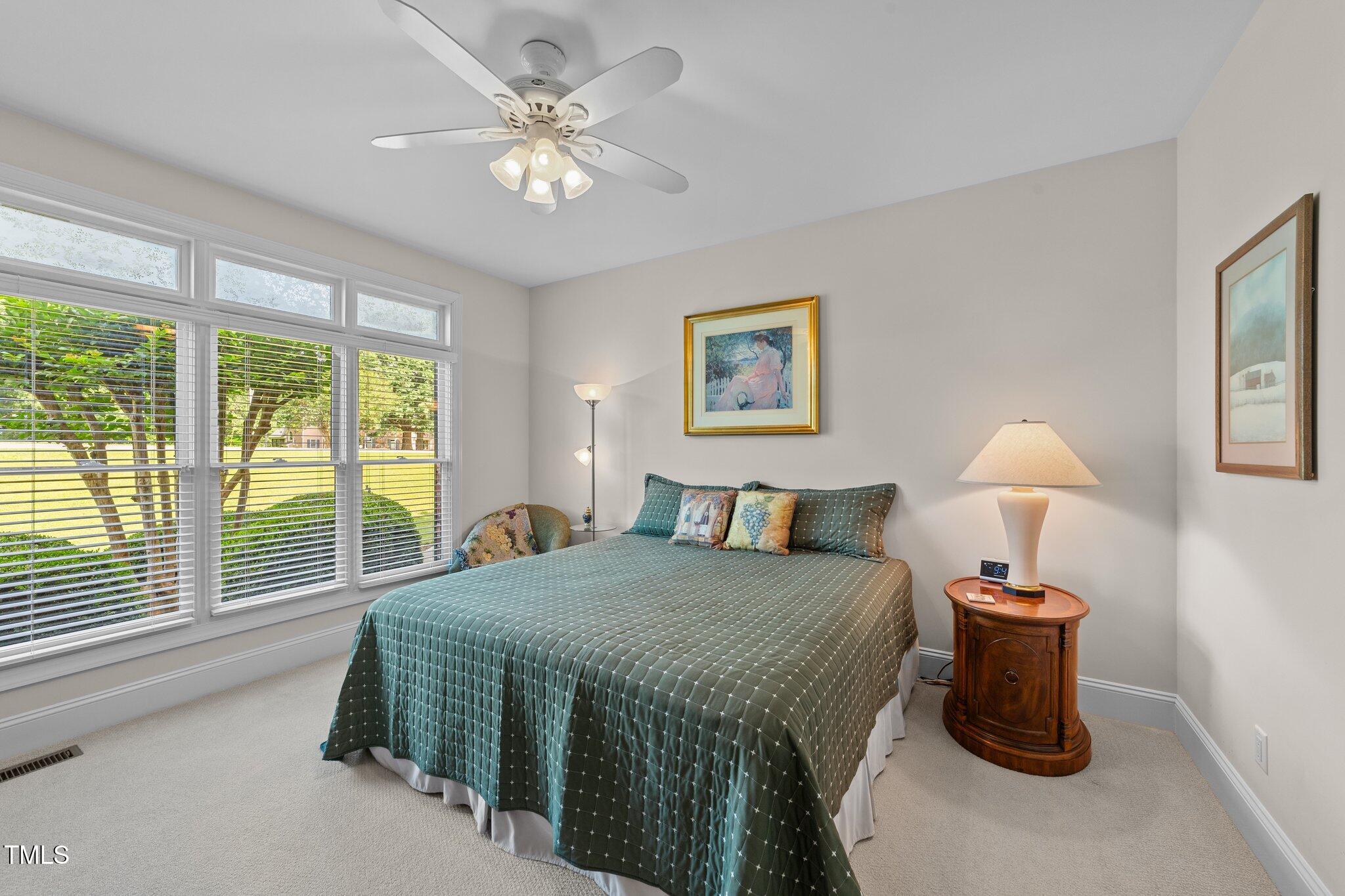 12504 Bayleaf Church Road Raleigh, NC 27614 - Photo 29 of 73 a bedroom with a bed and a chandelier