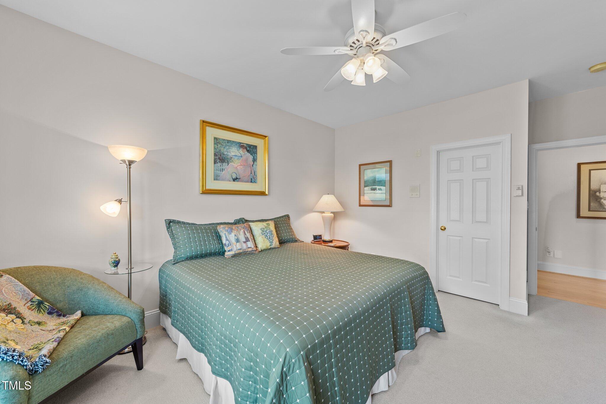 12504 Bayleaf Church Road Raleigh, NC 27614 - Photo 30 of 73 a bedroom with a bed and a chandelier