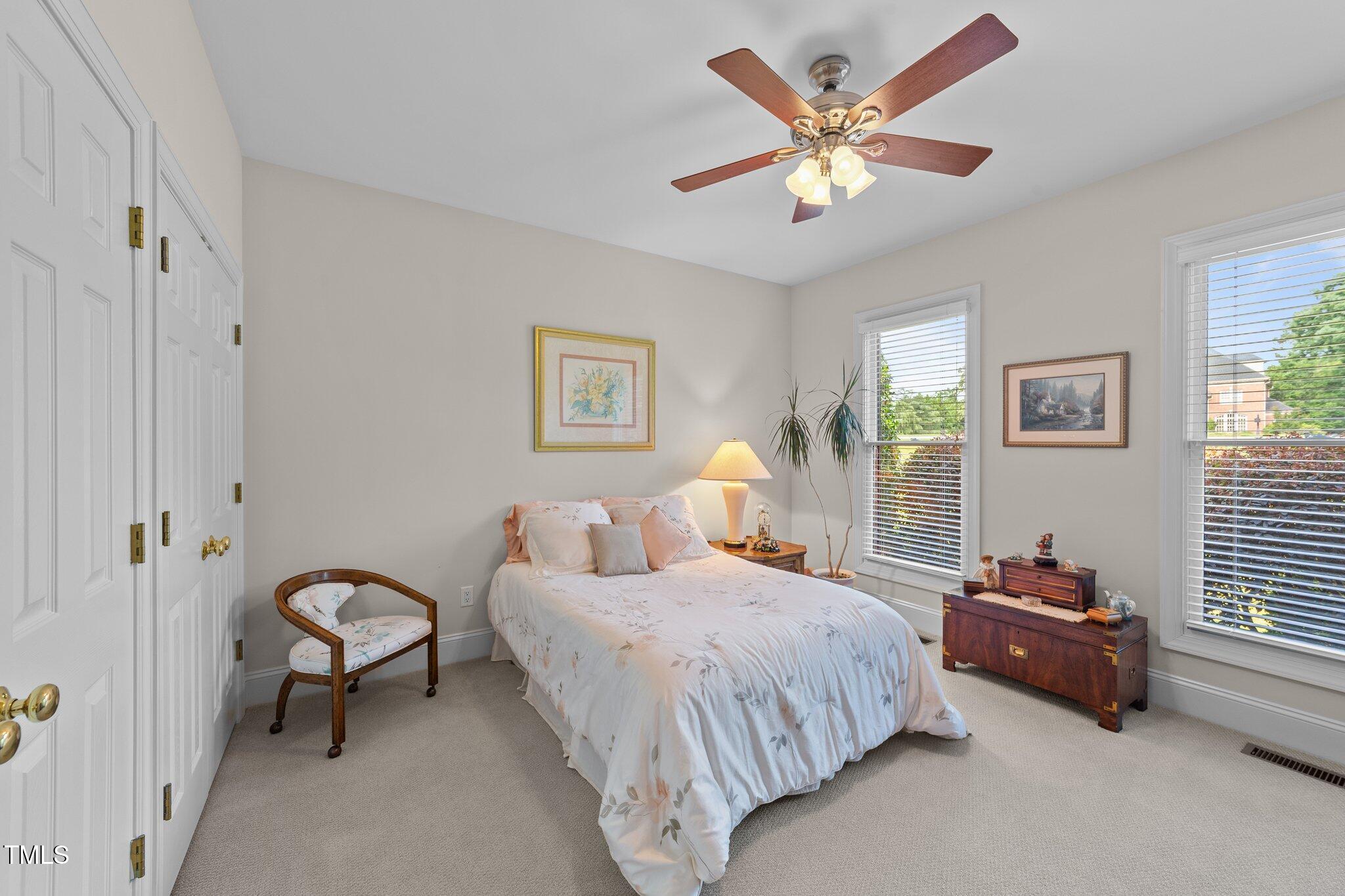 12504 Bayleaf Church Road Raleigh, NC 27614 - Photo 31 of 73 a bedroom with a bed and a chandelier