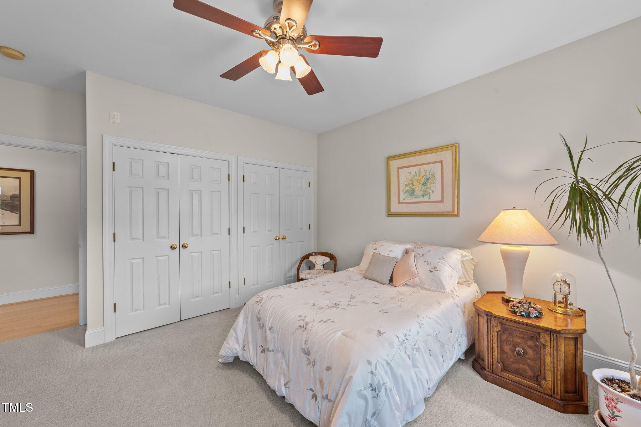 12504 Bayleaf Church Road Raleigh, NC 27614 - Photo 32 of 73 a bedroom with a bed and a chandelier
