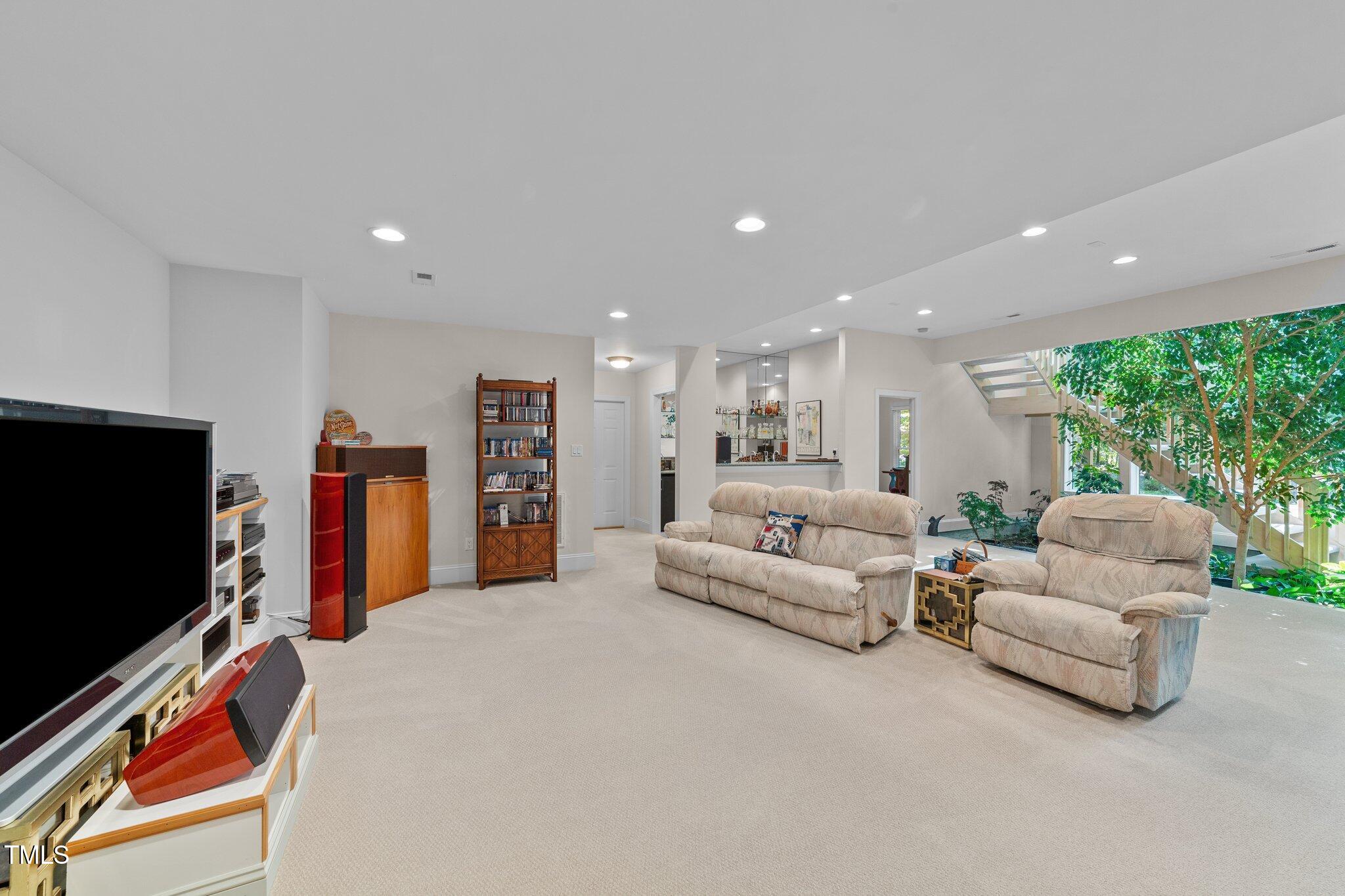 12504 Bayleaf Church Road Raleigh, NC 27614 - Photo 40 of 73 a living room with furniture and a flat screen tv