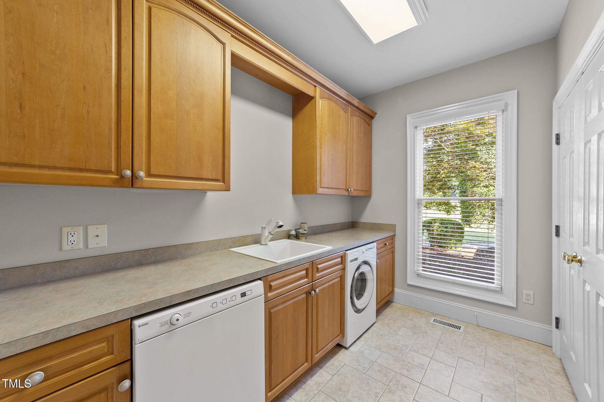 12504 Bayleaf Church Road Raleigh, NC 27614 - Photo 41 of 73 a kitchen with a sink and a window