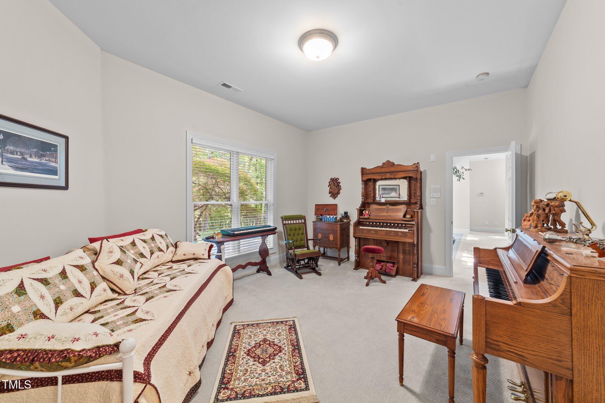 12504 Bayleaf Church Road Raleigh, NC 27614 - Photo 47 of 73 a bedroom with furniture and a wooden floor