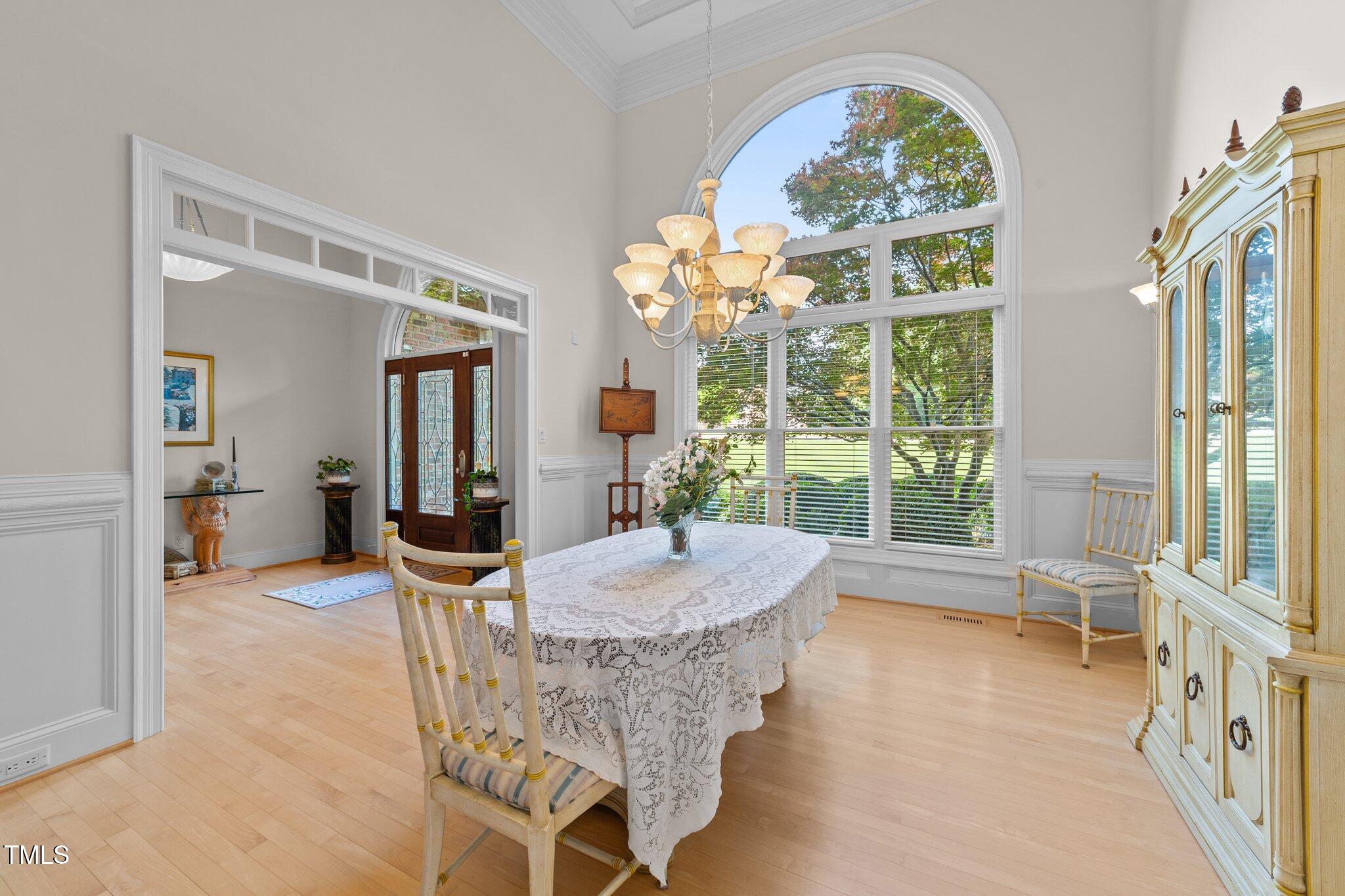 12504 Bayleaf Church Road Raleigh, NC 27614 - Photo 5 of 73 a dining room with furniture a chandelier and wooden floor