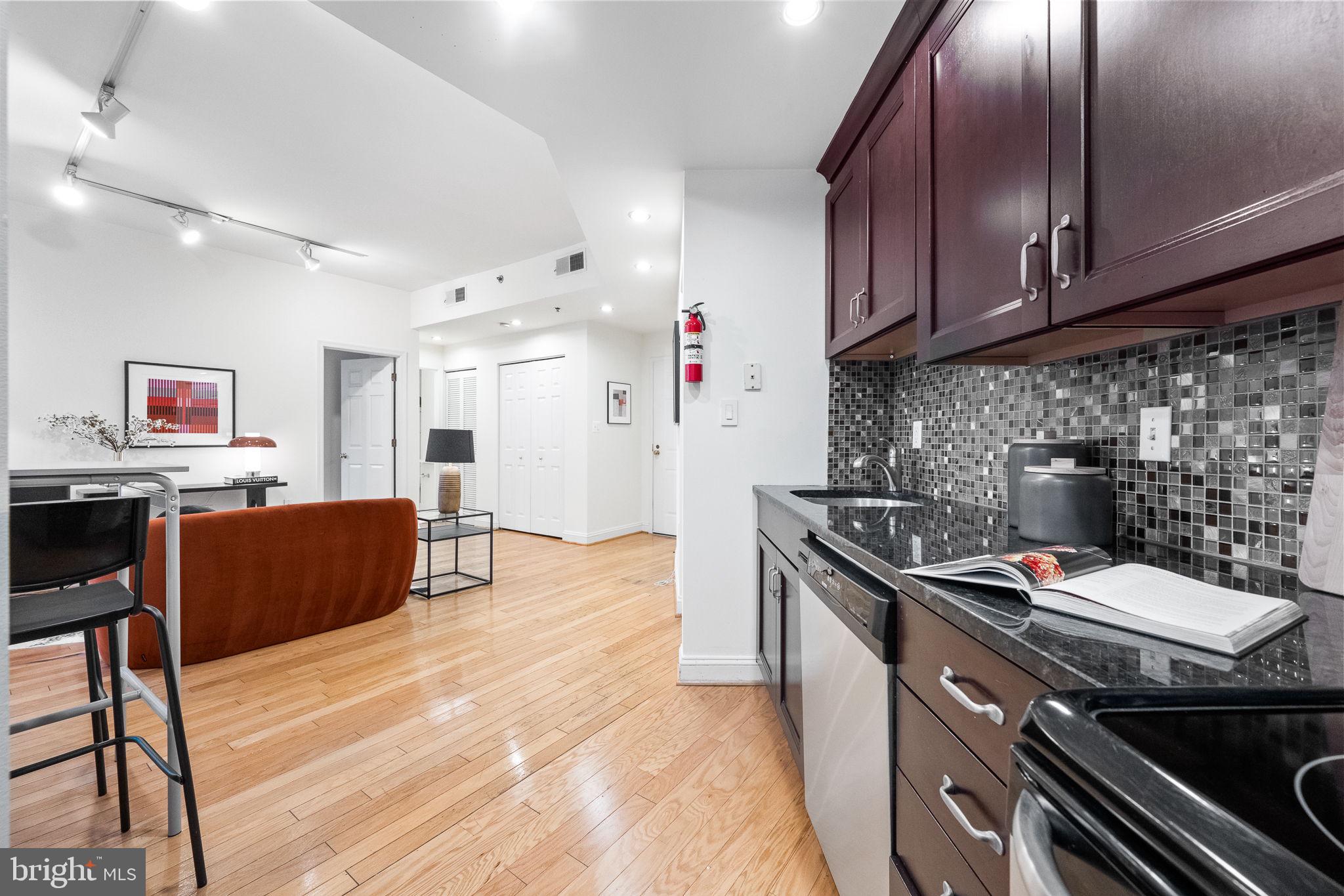 1621 T Street Northwest, Unit 207 Washington, DC 20009 - Photo 11 of 29 a kitchen with stainless steel appliances granite countertop a stove and a refrigerator