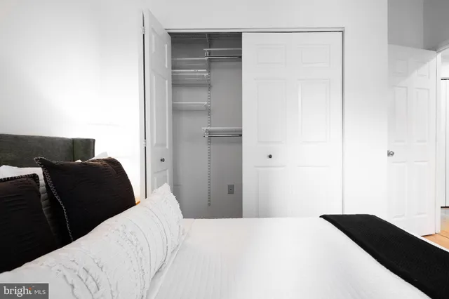 a bedroom with a bed and a walk in closet