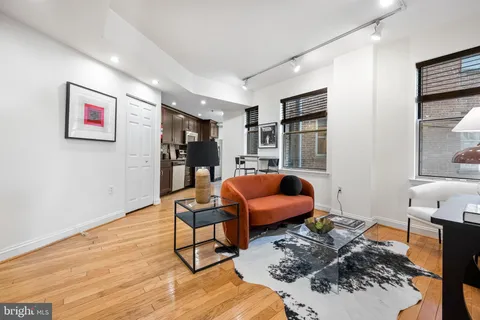 a bedroom with furniture and a book shelf