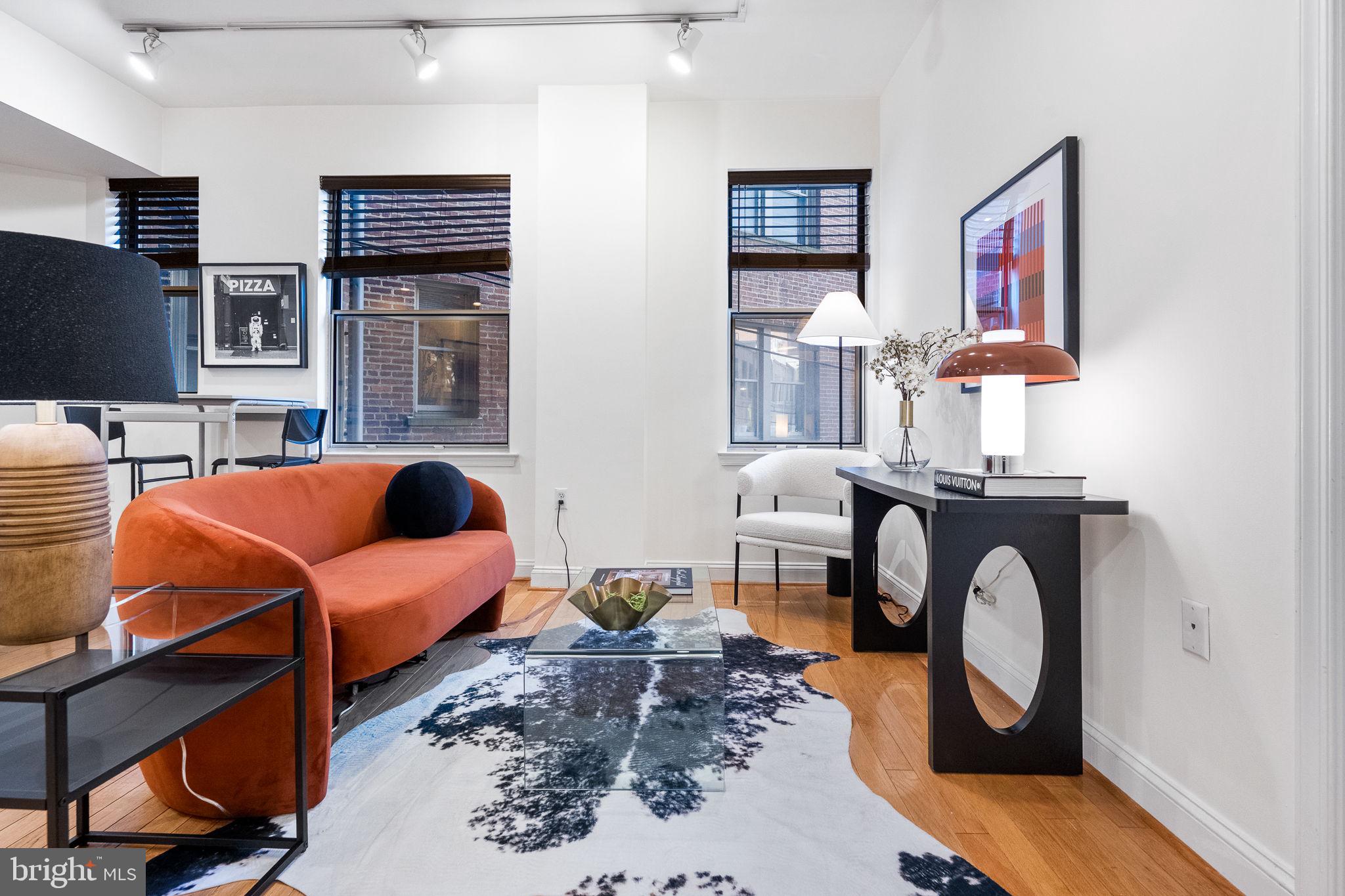 1621 T Street Northwest, Unit 207 Washington, DC 20009 - Photo 6 of 29 a living room with furniture a rug and white walls