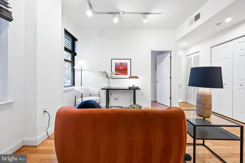 a bedroom with furniture and a flat screen tv