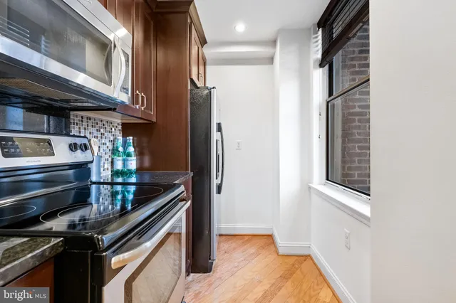 a kitchen with stainless steel appliances granite countertop a stove and a refrigerator