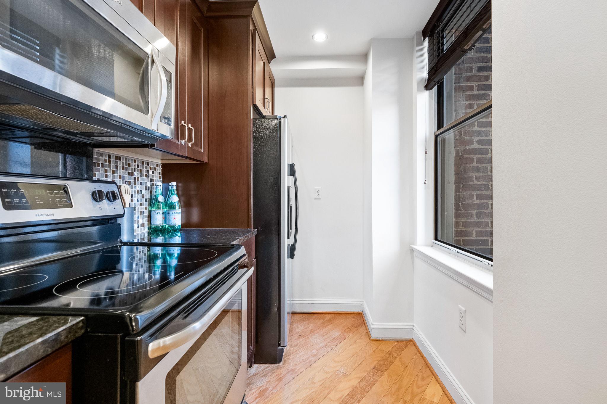1621 T Street Northwest, Unit 207 Washington, DC 20009 - Photo 10 of 29 a kitchen with stainless steel appliances granite countertop a stove and a refrigerator