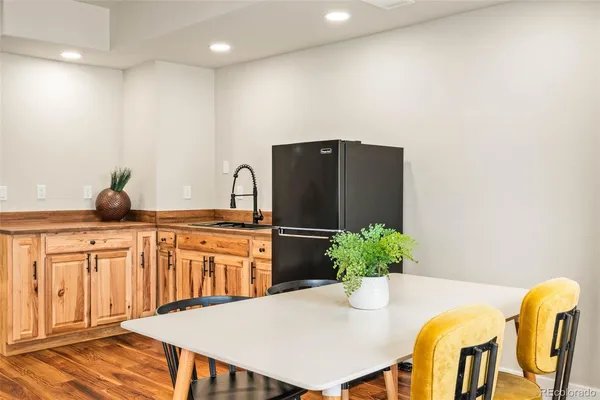 a kitchen with stainless steel appliances granite countertop a refrigerator a sink a stove and white cabinets