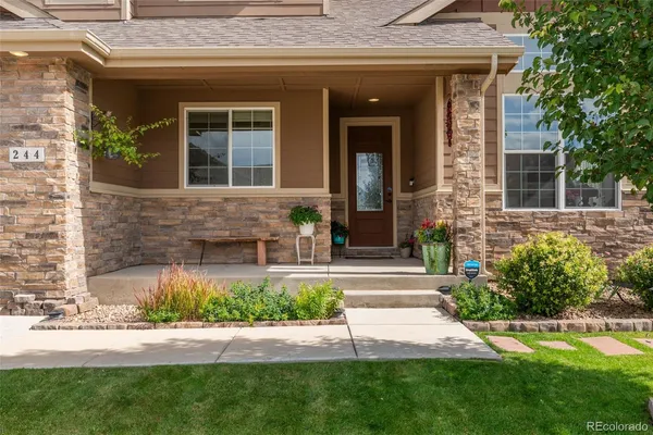 a view of a house with a yard and sitting area