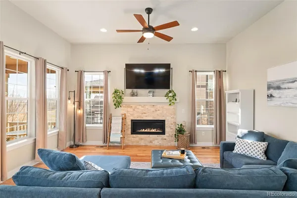 a living room with furniture a fireplace and a flat screen tv