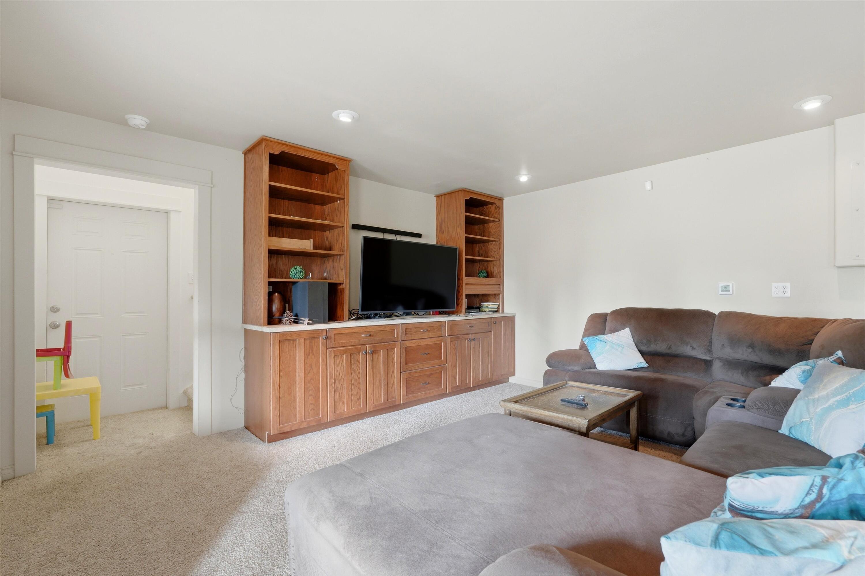 17179 Island Loop Way Bend, OR 97707 - Photo 13 of 52 a living room with furniture and a flat screen tv