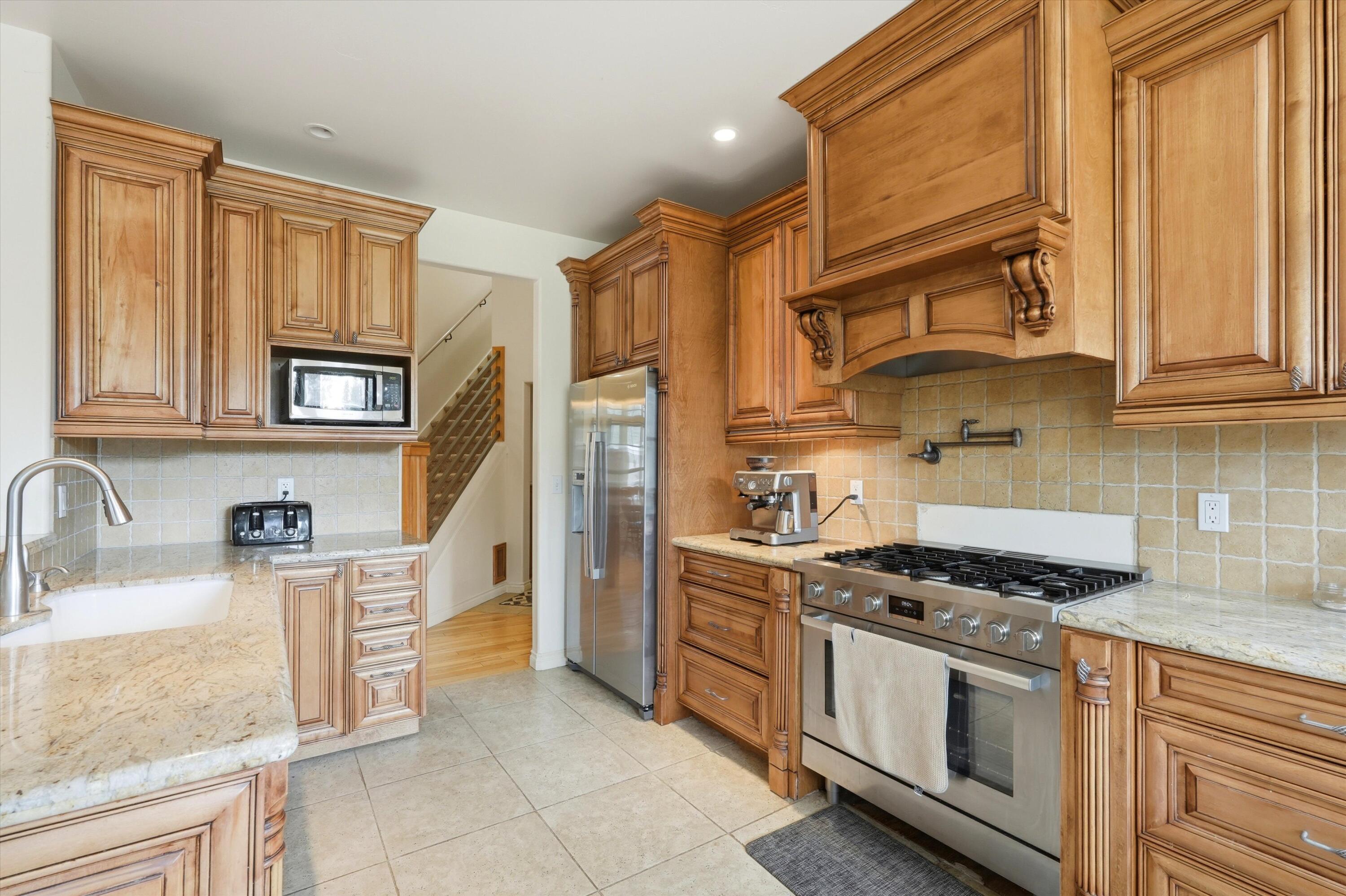 17179 Island Loop Way Bend, OR 97707 - Photo 15 of 52 a kitchen with stainless steel appliances granite countertop a stove a sink and a refrigerator