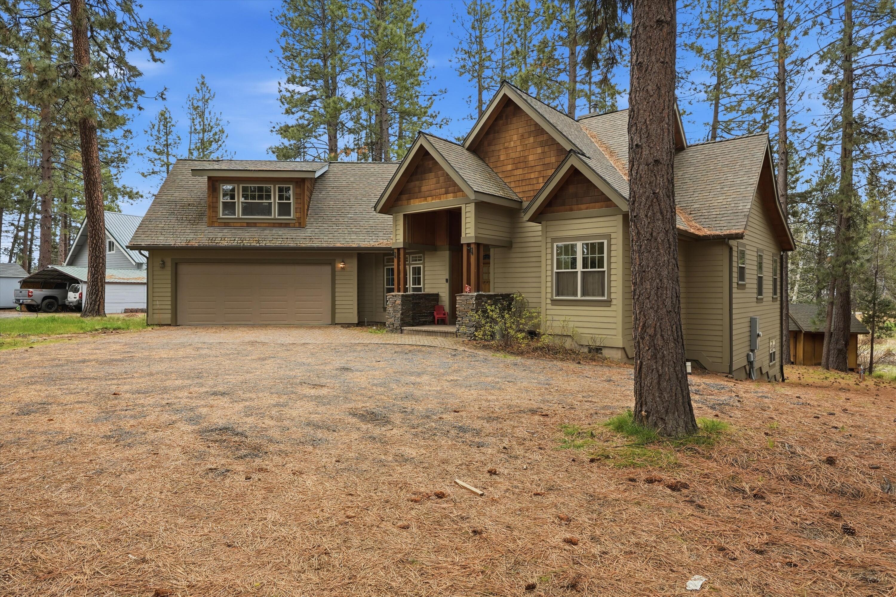 17179 Island Loop Way Bend, OR 97707 - Photo 1 of 52 a view of a house with a yard and garage