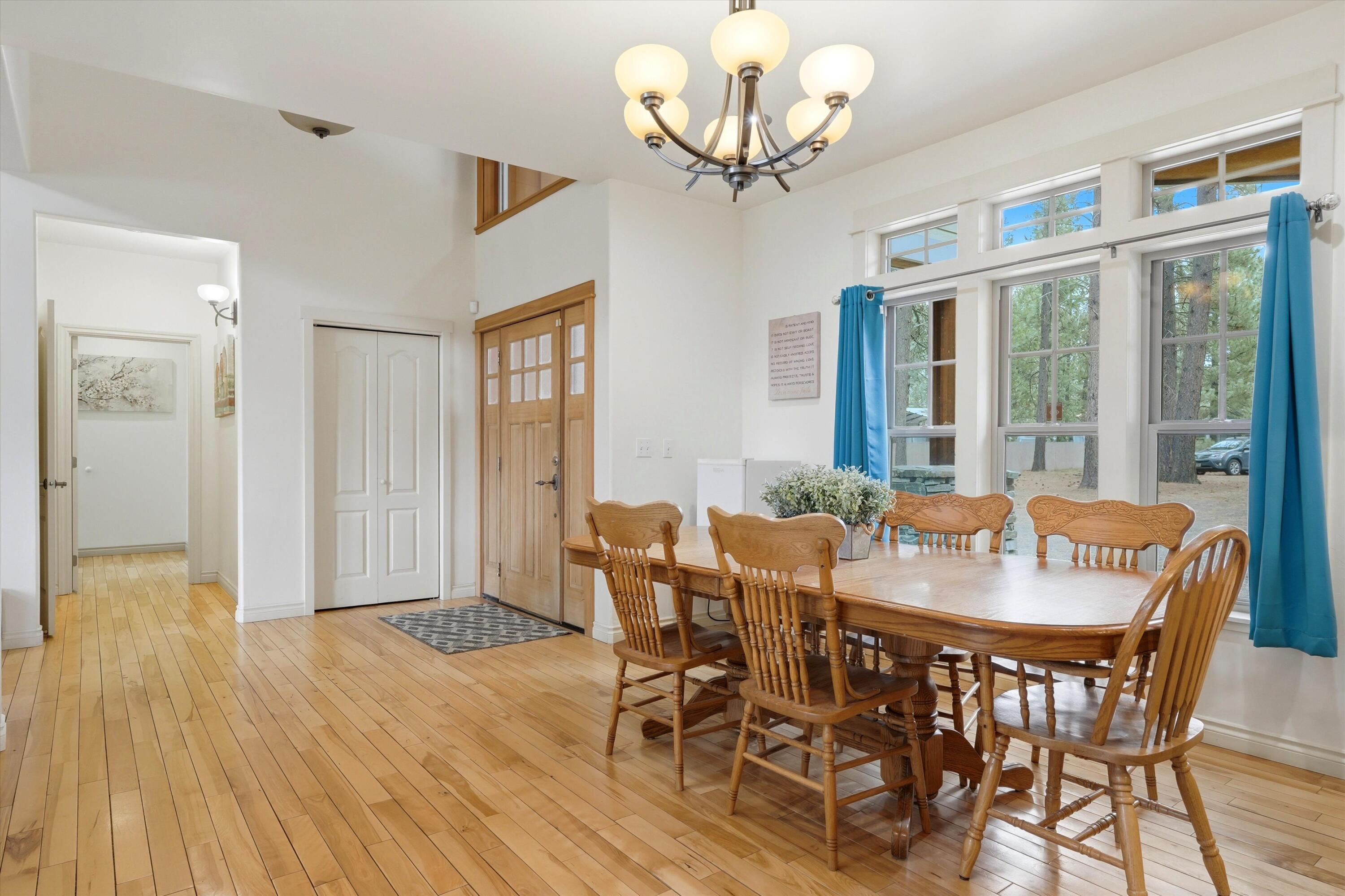 17179 Island Loop Way Bend, OR 97707 - Photo 17 of 52 a view of a dining room with furniture wooden floor and chandelier