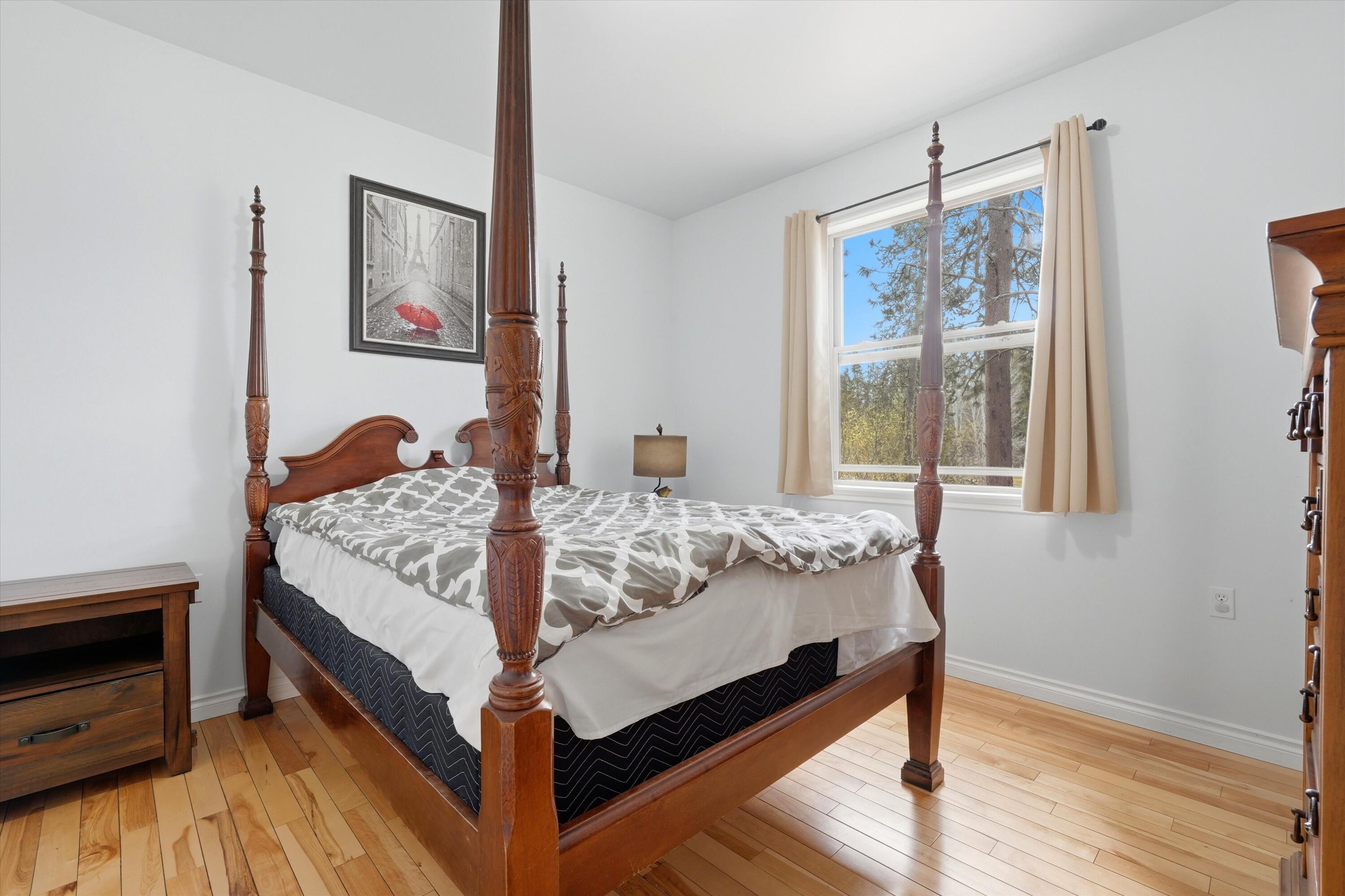 17179 Island Loop Way Bend, OR 97707 - Photo 22 of 52 a bed sitting in a bedroom next to a window