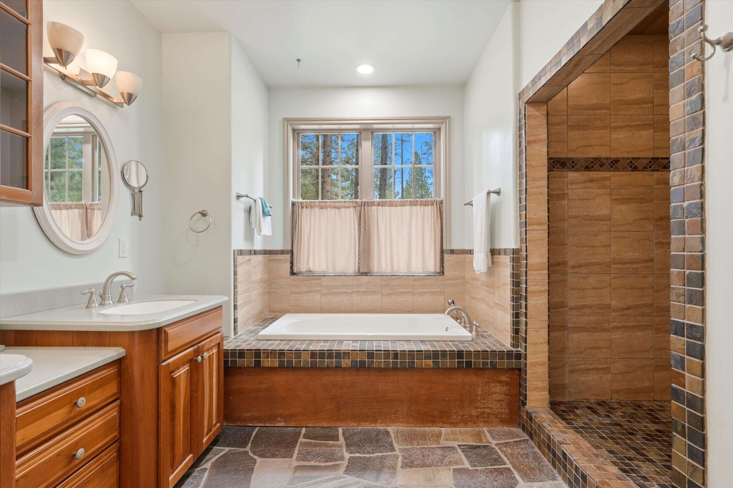 17179 Island Loop Way Bend, OR 97707 - Photo 26 of 52 a bathroom with a tub sink and mirror