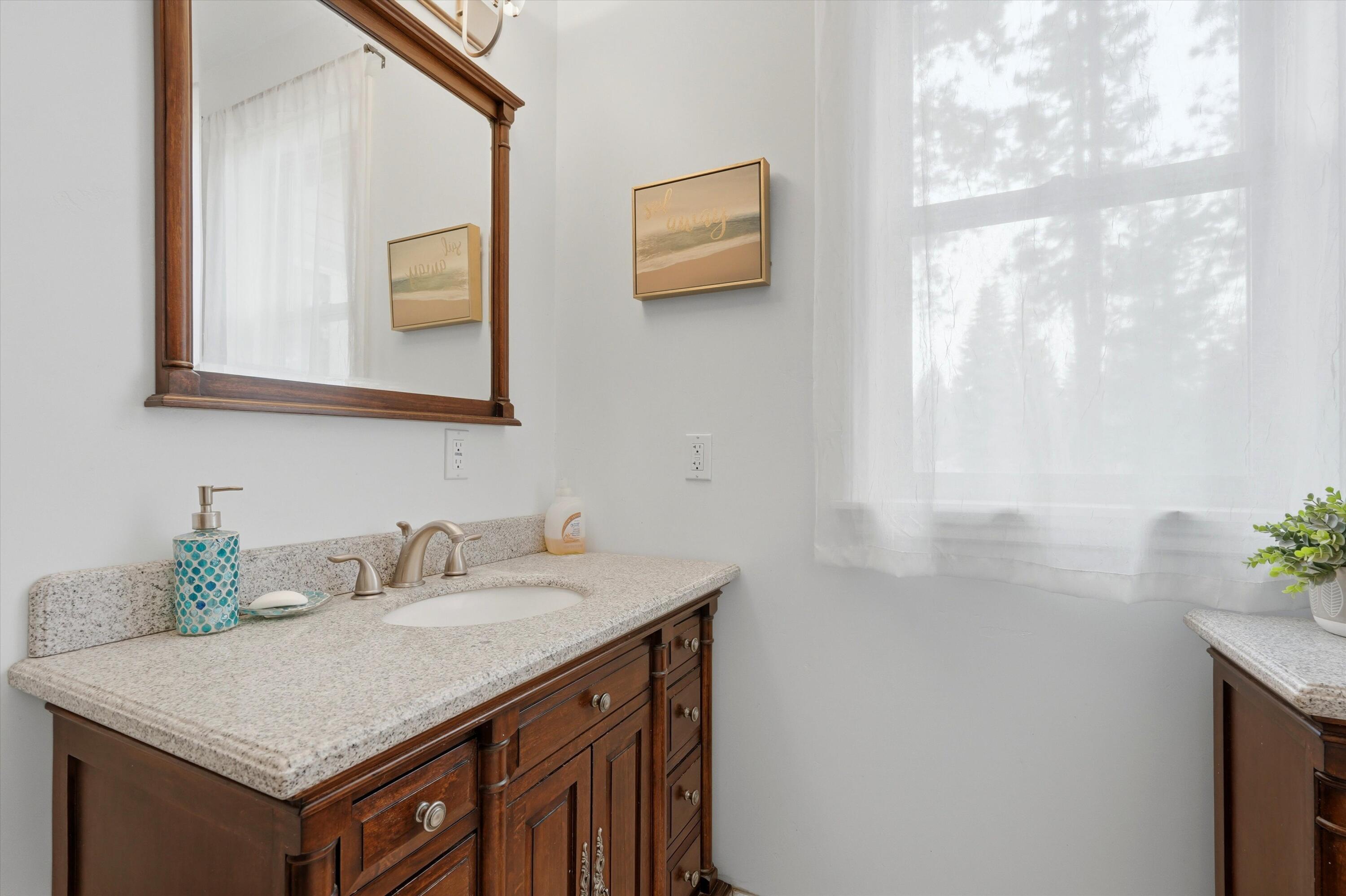 17179 Island Loop Way Bend, OR 97707 - Photo 28 of 52 a bathroom with a sink a vanity and a mirror