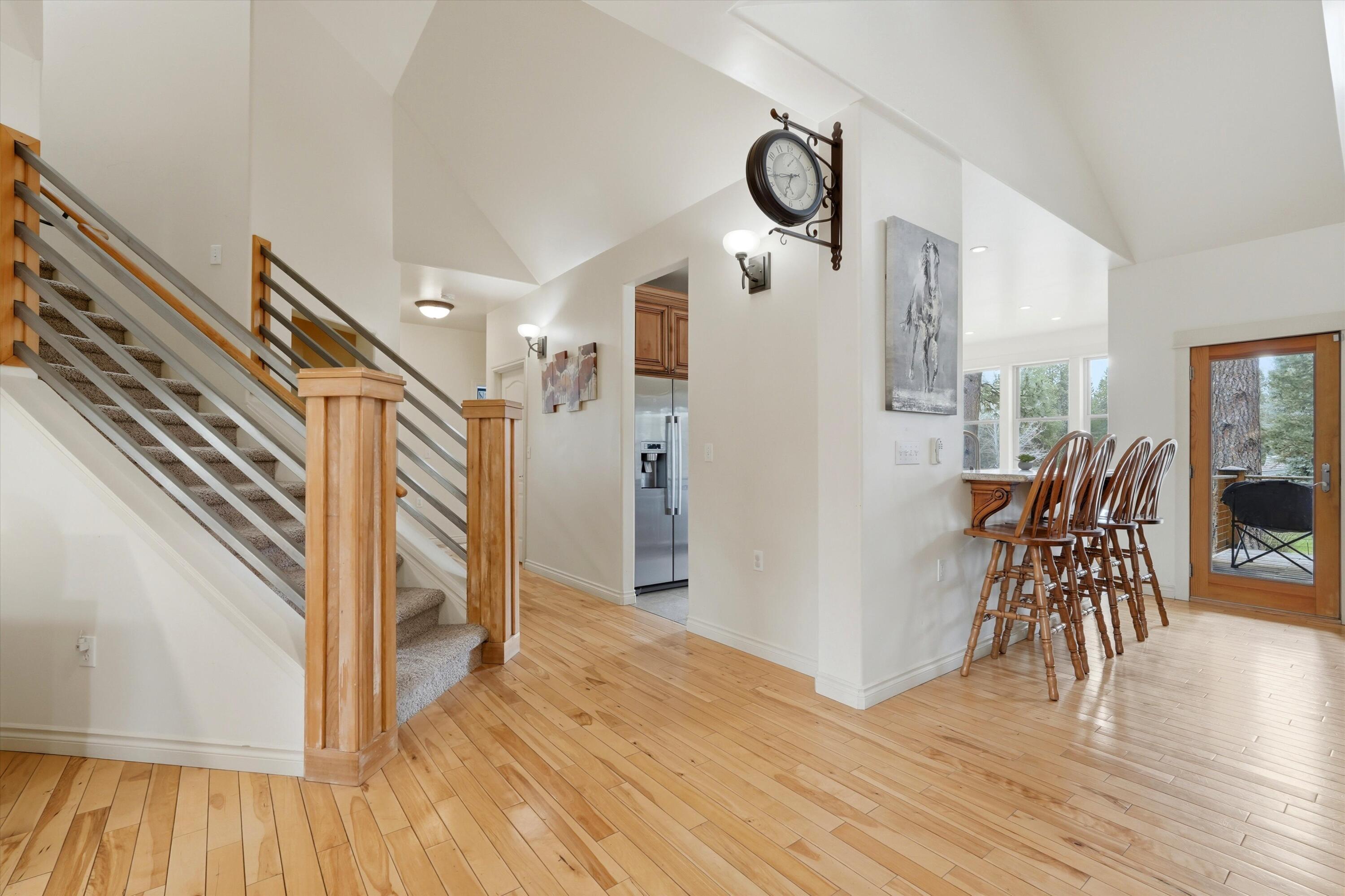 17179 Island Loop Way Bend, OR 97707 - Photo 4 of 52 a view of a hallway with wooden floor and dining room
