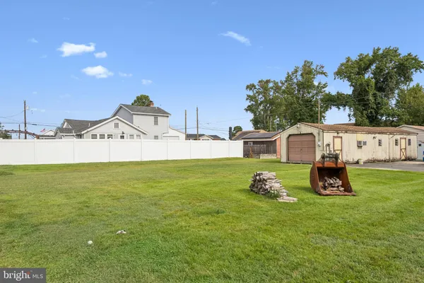 a white house with a yard and sitting area