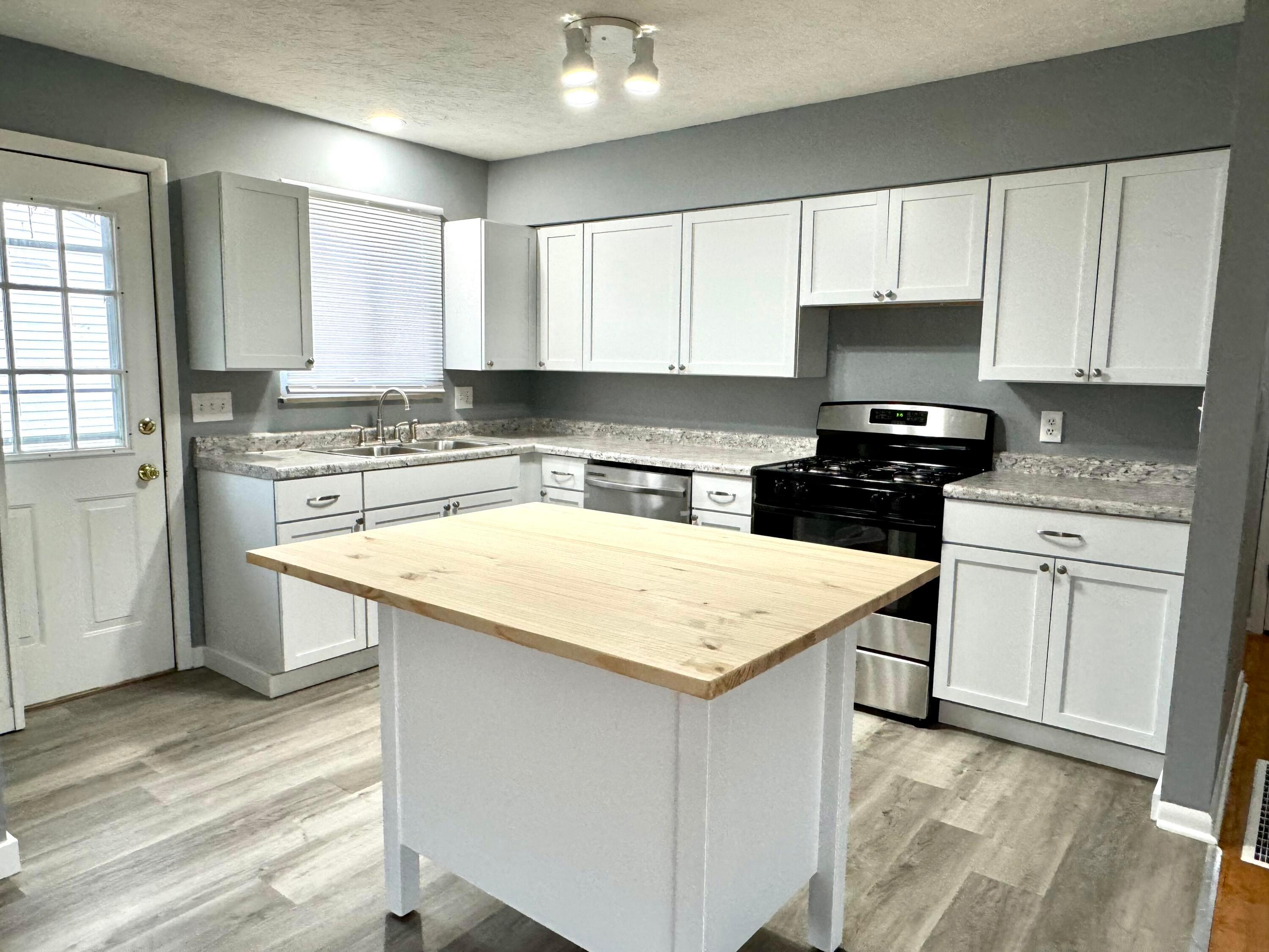 609 Raleigh Drive Columbus, OH 43228 - Photo 6 of 33 Brand new kitchen, and appliances with island and breakfast bar seating.