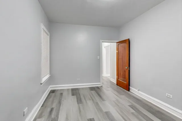 a view of room with window and wooden floor
