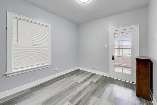 an empty room with windows and closet