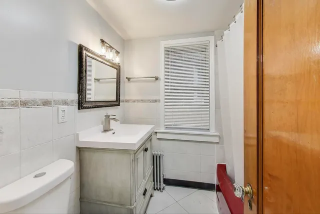 a bathroom with a sink a toilet and a mirror