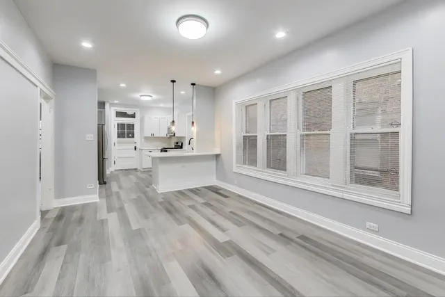 a view of kitchen with sink and refrigerator