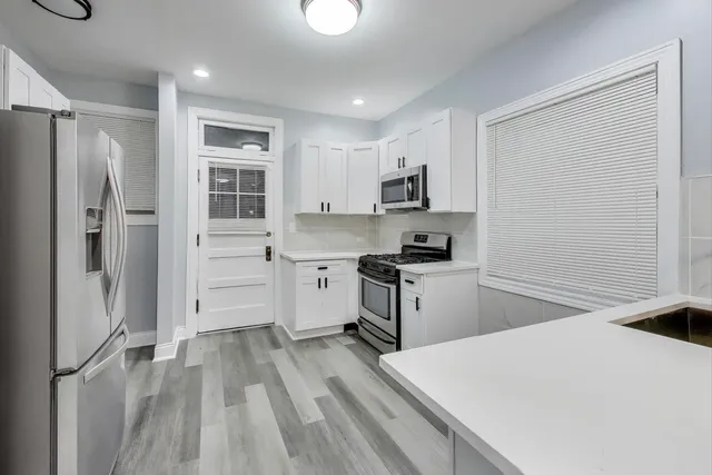a kitchen with a refrigerator stove and sink