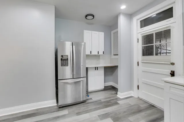 a refrigerator freezer sitting inside of a kitchen