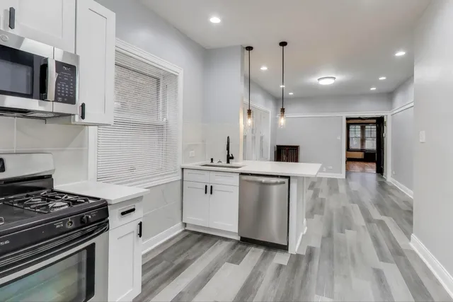 a kitchen with a stove oven and sink