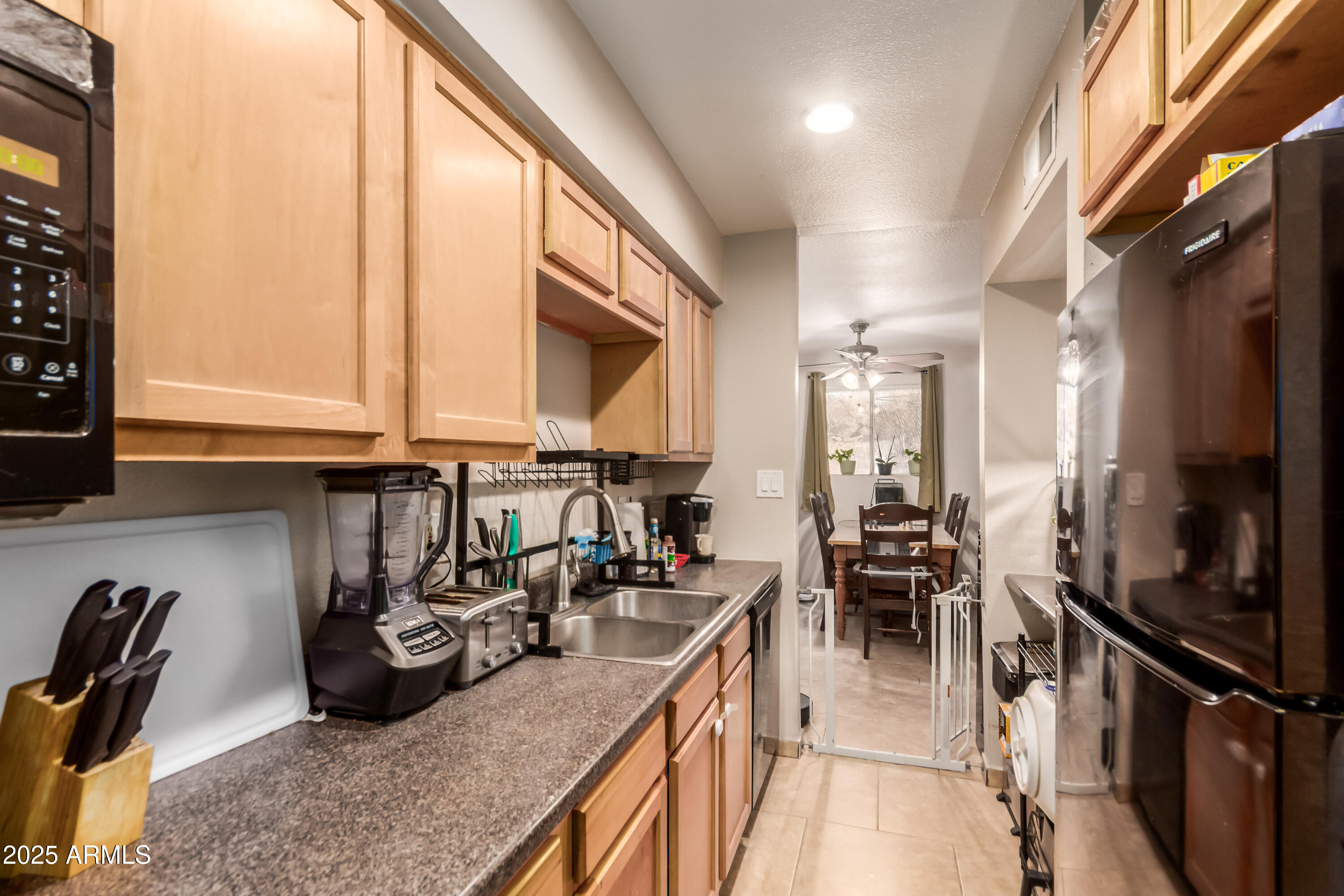 1130 East Butler Drive, Unit A1 Phoenix, AZ 85020 - Photo 7 of 31 a kitchen with granite countertop a sink a counter top space appliances and cabinets