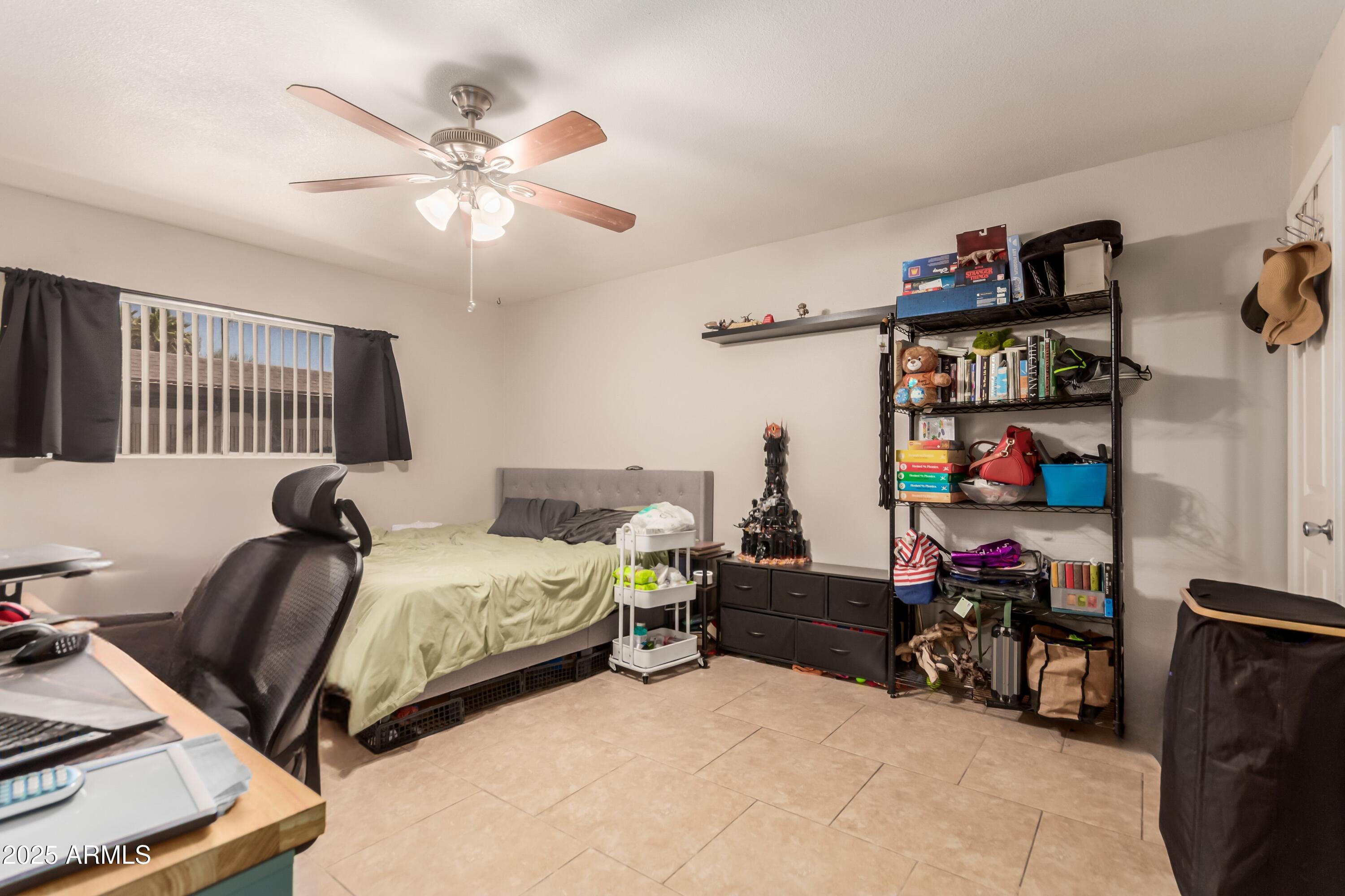 1130 East Butler Drive, Unit A1 Phoenix, AZ 85020 - Photo 9 of 31 a bedroom with bed and a chandelier