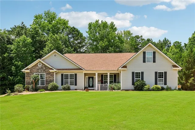 a front view of a house with a garden and porch