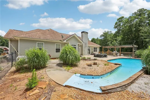 a view of a house with a yard and sitting area