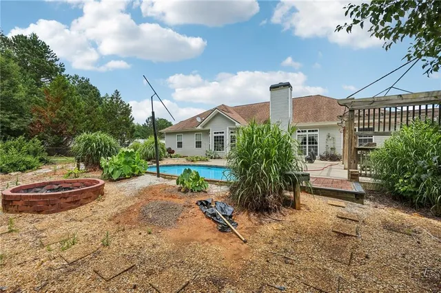 a aerial view of a house with swimming pool and garden