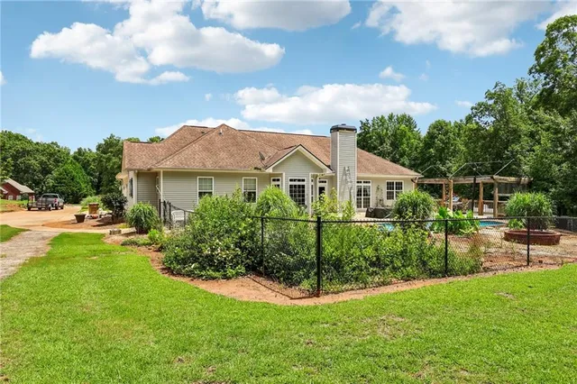a front view of a house with a garden