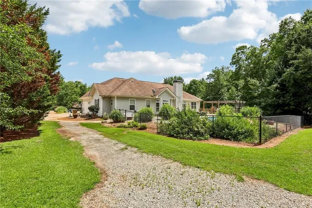 a aerial view of a house with swimming pool and garden