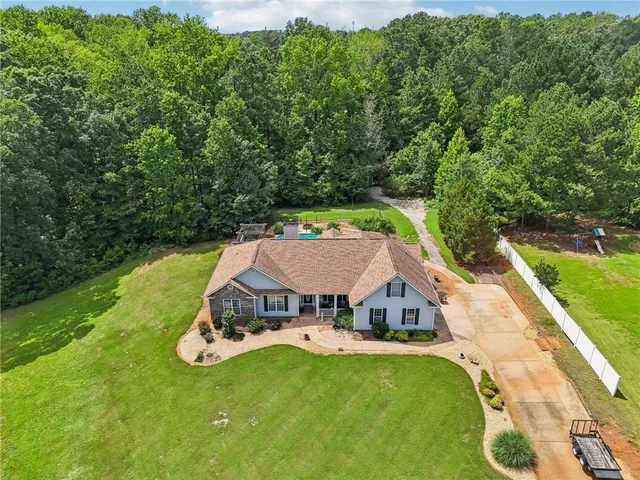 an aerial view of a house with a garden and swimming pool
