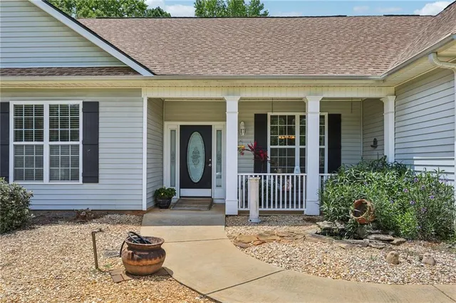 a view of an empty room with closet and a chandelier fan