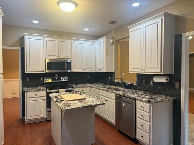 a dining room with furniture entryway and wooden floor