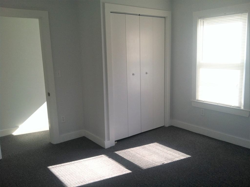 158 Main Street, Unit 2 Wenham, MA 01984 - Photo 11 of 13 an empty room with a window